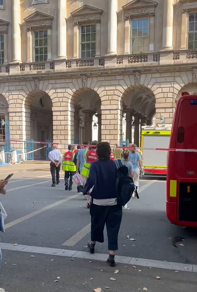 A woman outside Somerset House today after a blaze broke out in the building