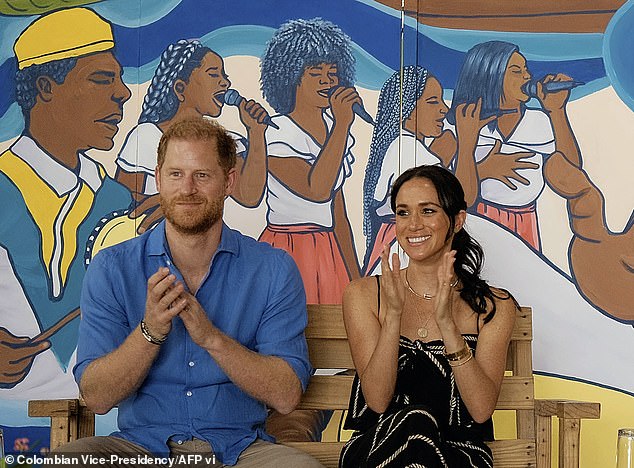 Harry and Meghan clapping during a performance at La Boquilla drum school