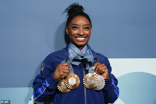 She won three golds - in the team event, all-around and vault - and took silver on the floor