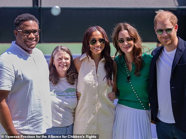 Alex Romain (left), chair of the Alliance for Children's Rights, joins Meghan (centre), Kelly McKee Zajfen (second right) and Prince Harry (far right) at the tournament on Saturday