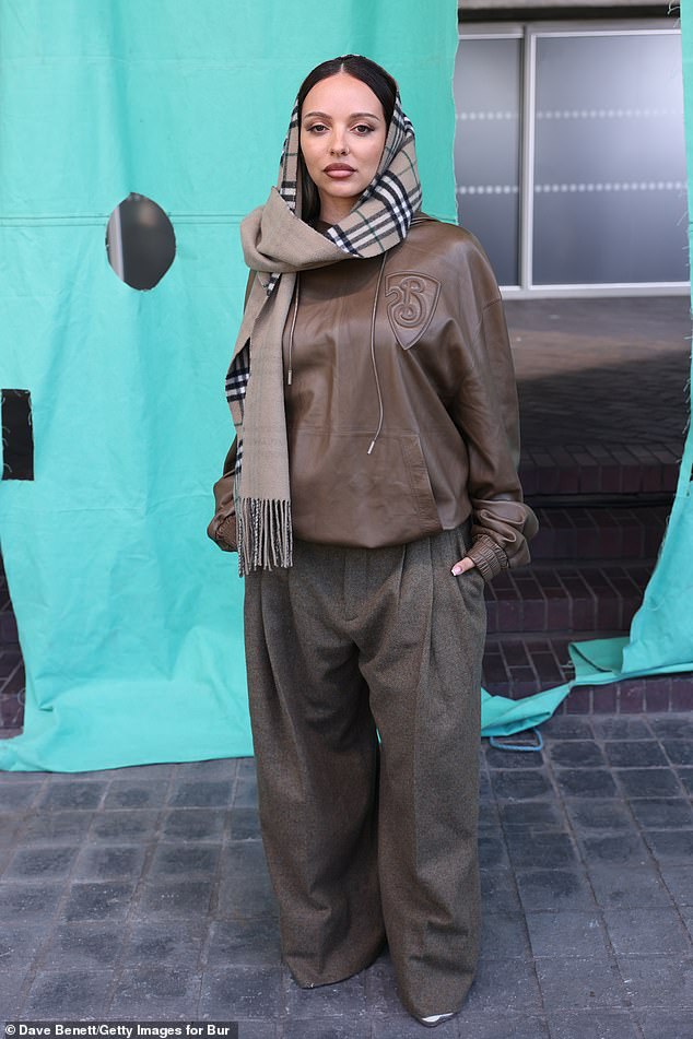 Jade wrapped up warm in a brown pleather hoodie and oversized trousers, with a signature Burberry scarf around her head