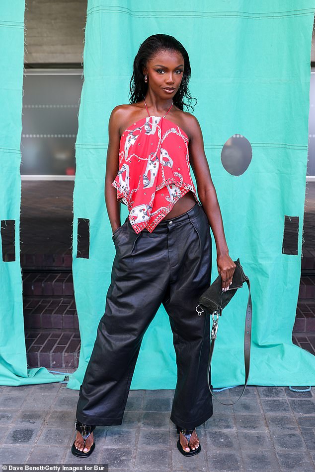 Leomie Anderson caught the eye in her bright red Shield Hardwear halterneck top teamed with black leather trousers