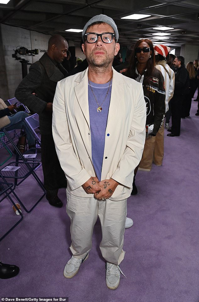 Blur and Gorillaz star Damon Albarn sported a knitted beanie with a purple jumper and cream suit for the show