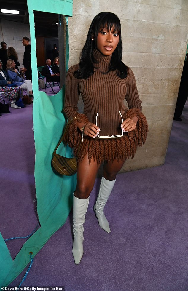 Normani put on a very leggy display, as she dressed to impress in a brown knitted minidress and heeled white knee-high boots