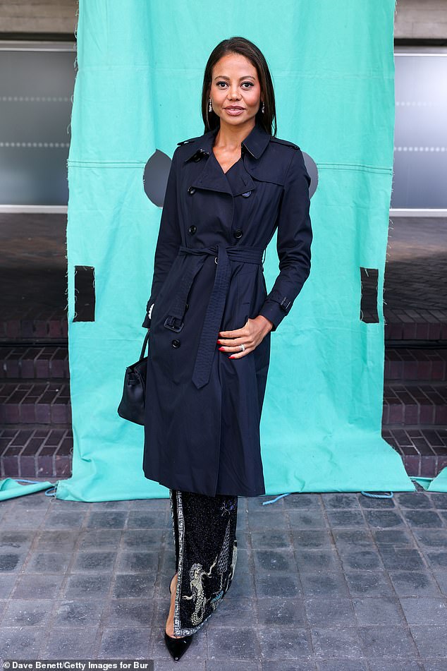 Marchioness of Bath, Emma Weymouth, looked chic in a navy trench coat over a beaded skirt