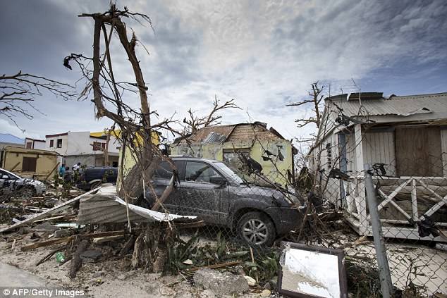 Irma destroyed the Dutch island of Sint Maarten, pictured above in a wrangle of destroyed homes, fences and trees