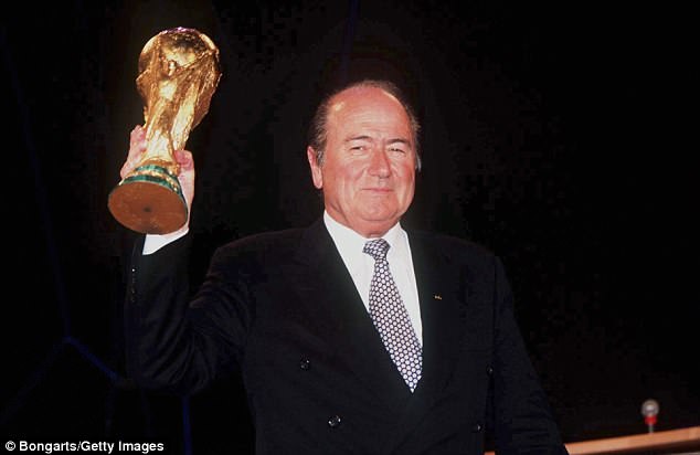 Sepp Blatter, seen holding the World Cup trophy in his right hand, was FIFA president in 1998