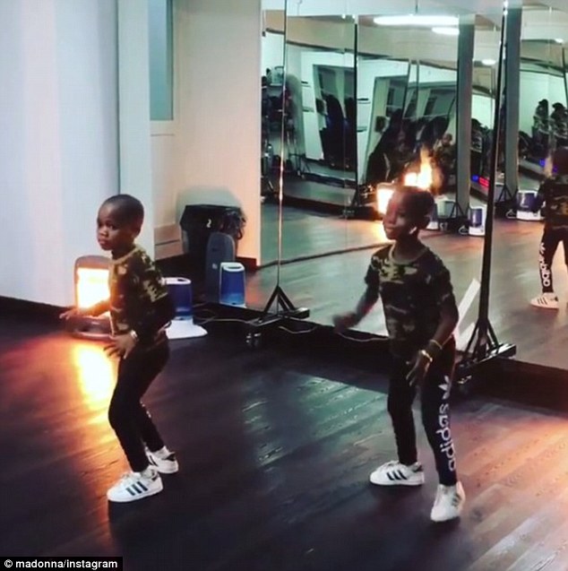 Esther and Stella, who were adopted form Malawi in February 2017, often perform perfectly coordinated dance routines (pictured in the studio with their mother  last year). The family has since relocated to Lisbon for their older brother David's football training 