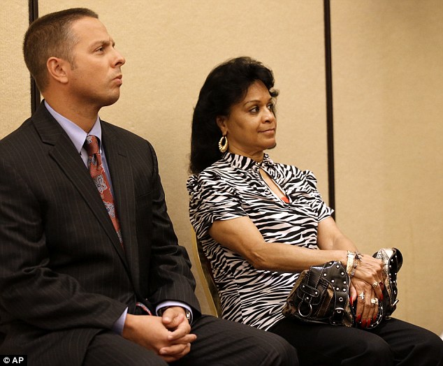 Gerry Washington, wife of Former Texas Rangers manager Ron Washington sits with Attorney Jason Lewis, left, as they both watch while Washington makes a statement at a news conference. It was the 62-year-old's first public comment since abruptly resigning 13 days earlier