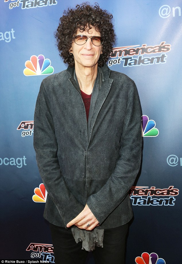 Suave: Howard Stern looked hip in gradient-lens glasses while sporting a grey coat, burgundy blouse, and black trousers