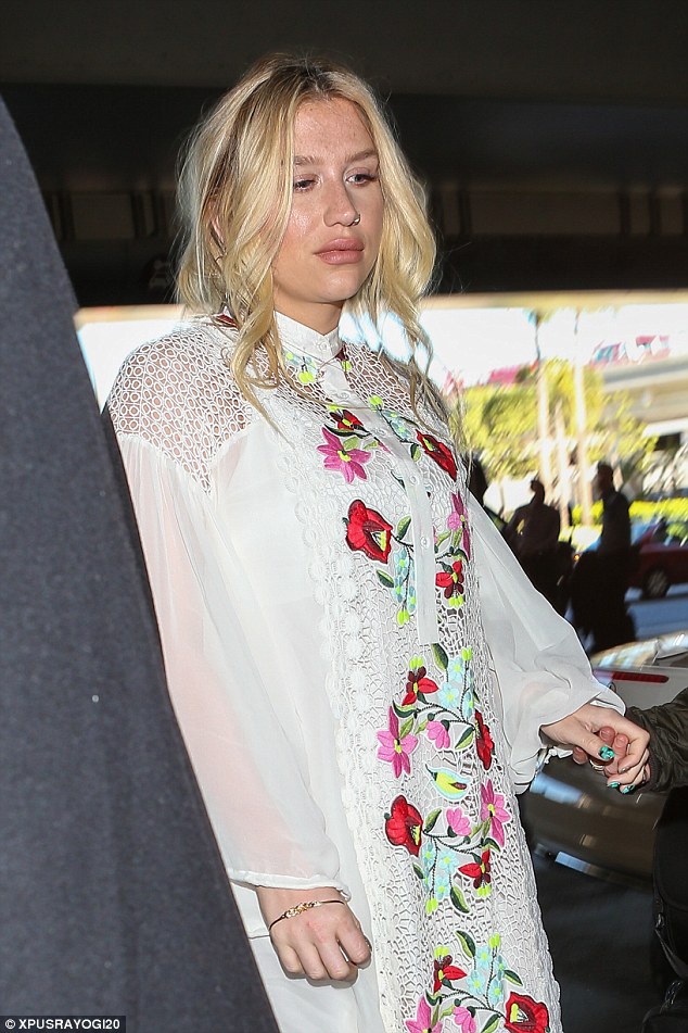 Flower power: The singer wore a long, flowing white gown with a bright floral design