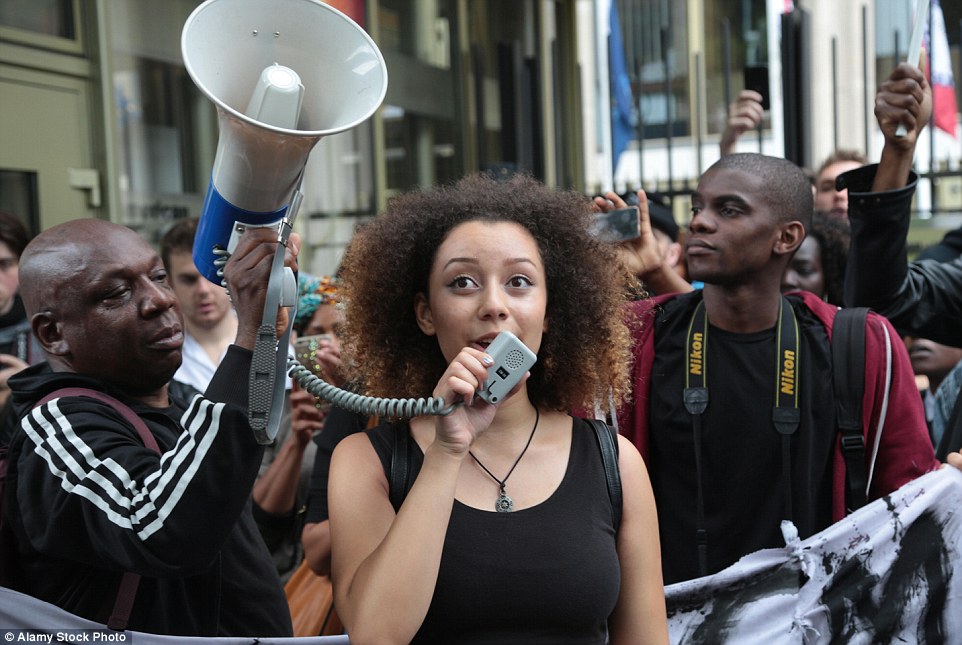 Capres Willow, one of the ringleaders of Black Lives Matter, speaks at a demonstration outside the US Embassy last month. She is pictured with Gary McFarlane (left) a member of the Socialist Workers Party who help organise the demo