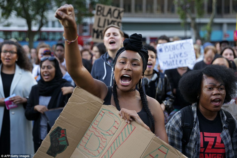 People chant and hold up with placards in Altab Ali Park in east London, as they attend the Black Lives Matter protest