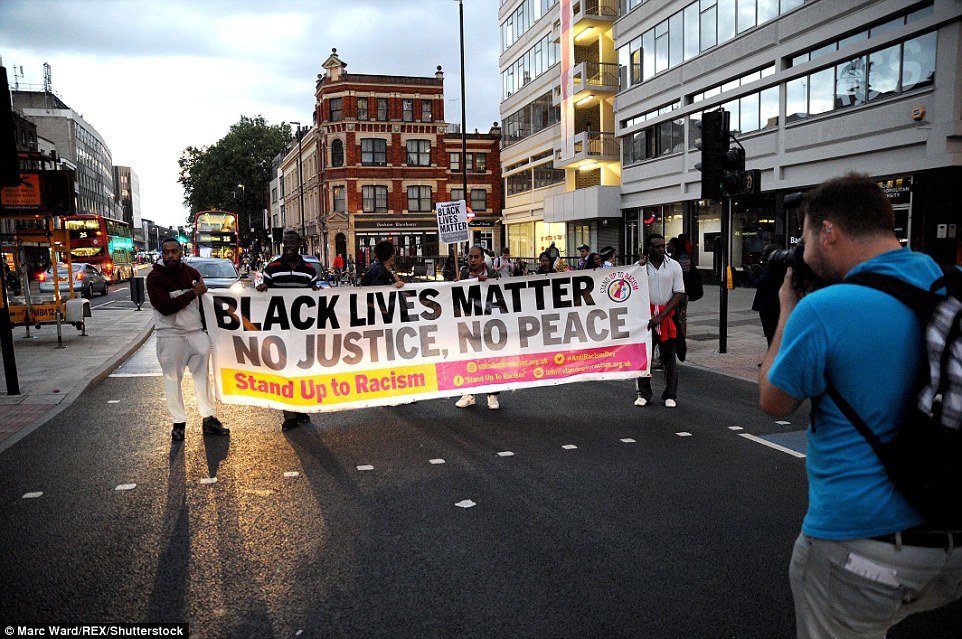 'No justice, no peace': The protesters marched down Aldgate High Street, blocking traffic and frustrating motorists