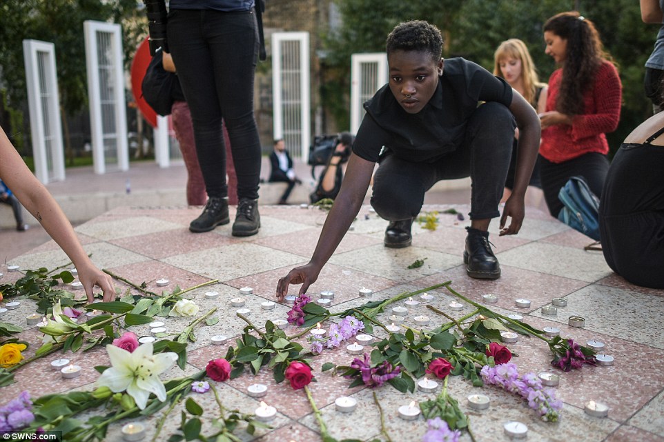 A woman lights a candle at a memorial during the Black Lives Matter protest in London. The event at Altab Ali Park in Whitechapel came after a day of protests across the country