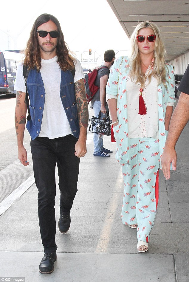 Pajama look: Kesha looked comfortable in a pajama-like ensemble as she arrived at LAX on Thursday with her beau Brad Ashenfelter