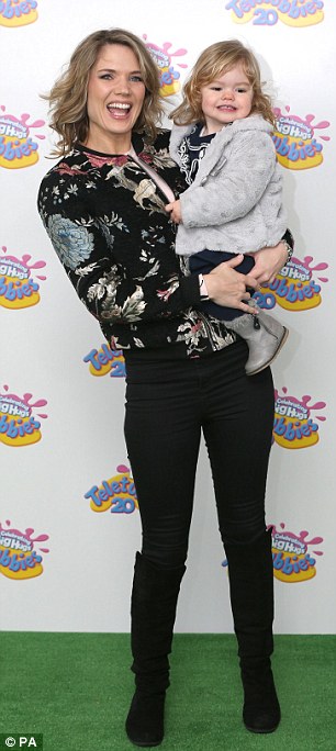 Mini me: Charlotte Hawkins made her way into the bash with her smiling daughter Ella Rose