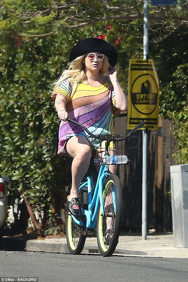 Pedal power: Kesha kicked back for a leisurely bike ride on Saturday