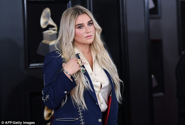 Raging on: He has denied the allegations, and filed a defamation lawsuit - which was dismissed. She remains tied to Sony although new album Rainbow is a victory (pictured on the Grammys red carpet) 