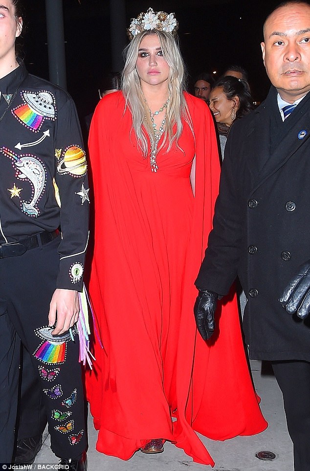 Emotional: The singer looked somewhat downcast as she arrived in her stunning red gown, featuring chic cape sleeves which extended all the way to the floor