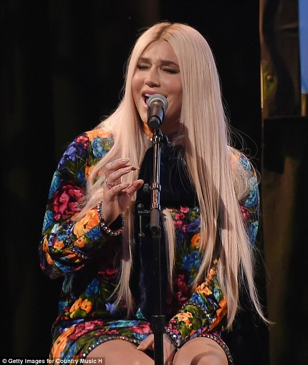 Dressed to impress: Looking effortlessly stylish for the performance, Kesha donned a vibrant floral dress with a velvet pussybow necktie