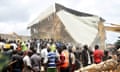 Dozens of people gather near a collapsed two-storey building