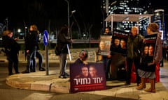 Demonstrators in Tel Aviv hold placards with photos of hostages kidnapped in the 7 October attack on Israel by Hamas