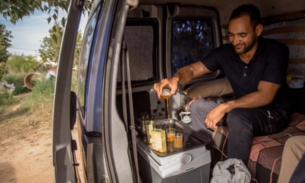 Ami Mohamed-Ali, from Western Sahara, pours tea in his van.