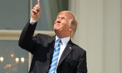 President Donald Trump points skyward before donning protective glasses to view the solar eclipse, Monday, Aug. 21, 2017, at the White House in Washington . (AP Andrew Harnik)