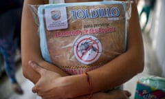 A pregnant woman holds a mosquito net in Cali, Colombia