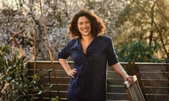 Charlotte Mendelson's garden. Charlotte in her roof garden with blossom behind