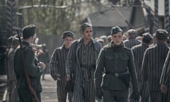 Lali Sokolov (Jonah Hauer-King) walks through Auschwitz with the Nazi officer Stefan Baretzki (Jonas Nay)