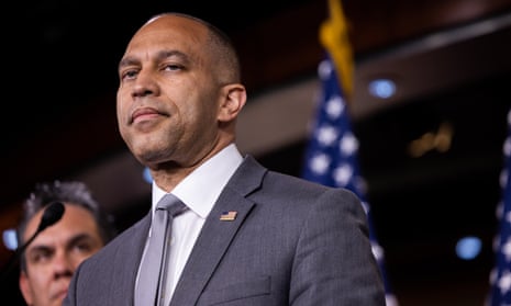 man stands at podium, slightly frowning