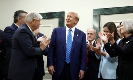 People applaud man in suit and blue tie