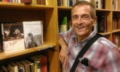 John Evans in bookshop, with copy of Journeying Boy
