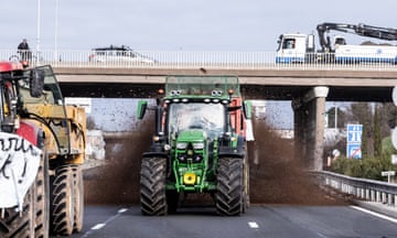 Farmers block a motorway in Lyon, France, as part of a nationwide protests against rising production costs and environmental regulations