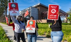 Workers carry strike signs outside a unionized Starbucks in Anaheim, California, for ‘Red Cup Rebellion’ in November 2022. 