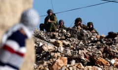 A Palestinian protestor looks towards Israeli security forces during clashes following a demonstration against the expropriation of Palestinian land by Israel in the village of Kfar Qaddum, near Nablus, in the occupied West Bank on January 6, 2017. / AFP PHOTO / JAAFAR ASHTIYEHJAAFAR ASHTIYEH/AFP/Getty Images