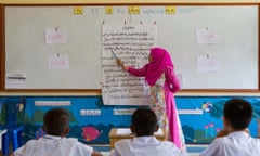 At Banbuengnamsai primary school, which signed up for a pilot programme,  a teacher gives an Arabic lesson.