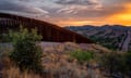 a fence dividing terrain at sunset