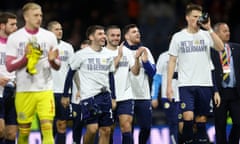 Scotland's Billy Gilmour, Andrew Robertson and John McGinn wear ‘We're off to Germany’ shirts after qualifying for Euro 2024.