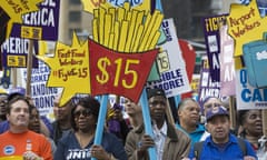 New York City joins fight for $15 minimum ‘living wage’<br>15 Apr 2015, New York City, New York State, USA --- New York, United States. 15th April 2015 -- Activists hold placards at New York City’s ‘Fight for $15’ march and rally. -- New York City workers took to the streets as they marched from Columbus Circle to Times Square demanding that the minimum wage be increased to $US15 per hour. --- Image by Angel Zayas/Demotix/Corbis