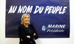 Marine Le Pen poses in front of a poster for her 2017 French presidential election campaign.