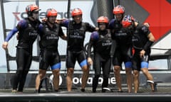 The crew of Emirates Team New Zealand embrace after defeating Oracle Team USA
