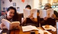 Three students of Michael Lujan Bevacqua's CHamoru language classes hold up CHamoru dictionaries.