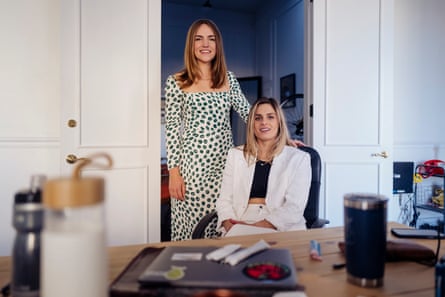 women pose at desk