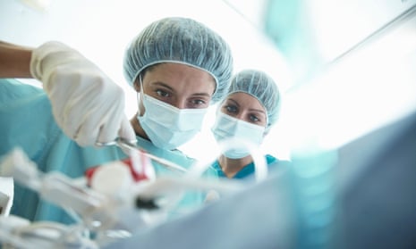 Surgeons concentrating in hospital operating theatre