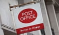 a red and white Post Office sign outside a branch, seen in close-up