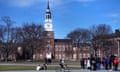 A bicyclist passes a college tour group outside the Baker Library at Dartmouth College, in Hanover, New Hampshire, in April 2023. 