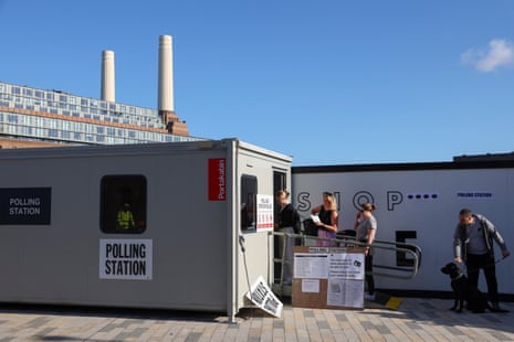 People queue to enter a polling station near Battersea Power Station.